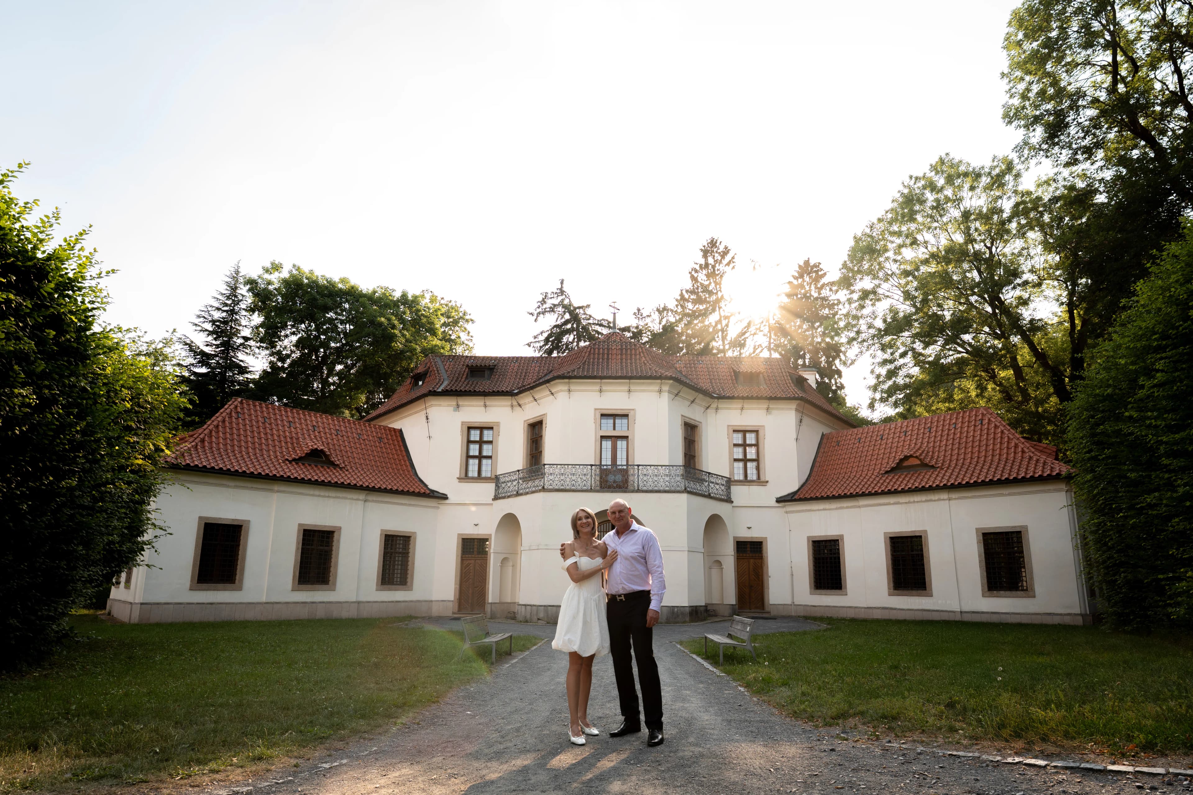Couple de mariés devant le château baroque de Prague au coucher de soleil, photographe de mariage Prague Clément Bayard